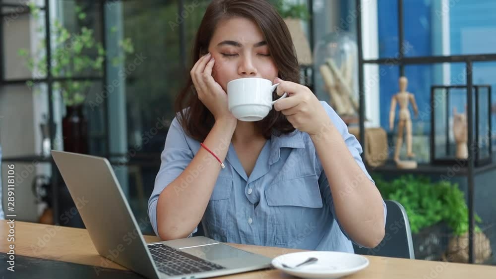 Asian woman drinking coffee in coffee shop cafe Asian woman drinking coffee in coffee shop cafe