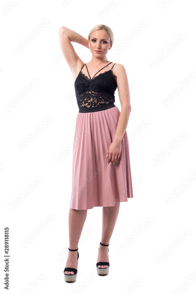 Blonde young pretty fashion woman in stylish clothes posing and looking at camera. Full body isolated on white background.