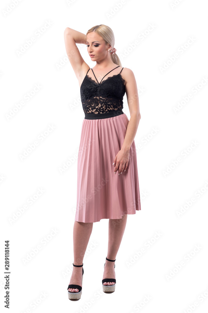 Affectionate elegant blonde beauty fashion model woman holding hair and looking down. Full body isolated on white background. Affectionate elegant blonde beauty fashion model woman holding hair and looking down. Full body isolated on white background.
