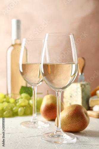 Grape, cheese, pears, glasses and bottle with wine, on white background, copy space