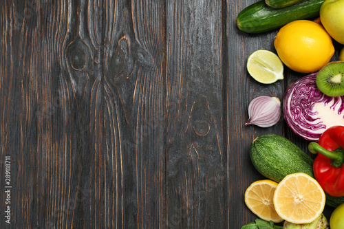 Different vegetables and fruits on wooden background, copy space