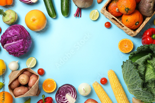 Fototapeta Naklejka Na Ścianę i Meble -  Different vegetables and fruits on blue background, copy space