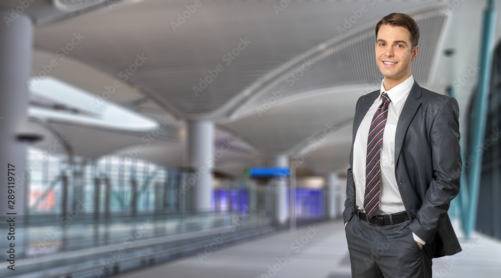 Confident handsome businessman on interior background Confident handsome businessman on interior background