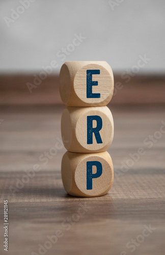 Cubes and dice with ERP Enterprise-Resource-Planning on wooden background