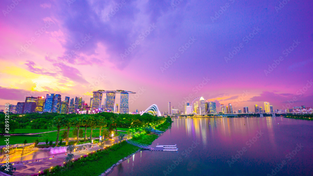 Fototapeta premium Royalty-free stock photo ID: 1488208352 Landscape of Singapore city during the twilight time and thunderbolt with marina bay sand tower, and Singapore flyer and Gardens by the Bay background. Tourist