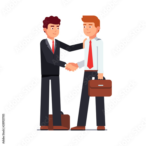 Business man shaking hands looking at each other