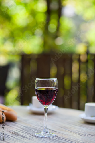 Glass with red wine on the table in a outdoor cafe