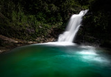 Emerald green waterfall at Du Gia, at the Ha Giang loop in Northern Vietnam. Stunning landscape long exposure photo. 