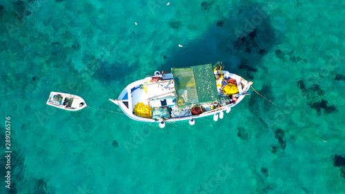 Aerial drone photo of picturesque and traditional colourful fishing boat docked in port of Koufonisi island, Small Cyclades, Greece © aerial-drone