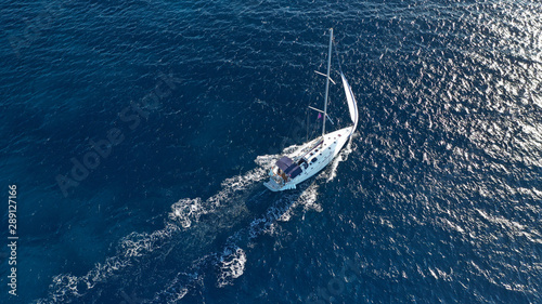 Aerial drone photo of luxury sail boat cruising in the deep blue Aegean sea, Greece