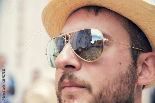 Self-portrait of Enrico Tricoli, with glasses reflecting the streets of Trinidad in Cuba.