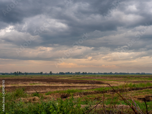 twilight and dark cloud over the abandoned field