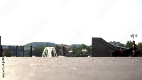 Skater doing a 360 flip on the flatground photo