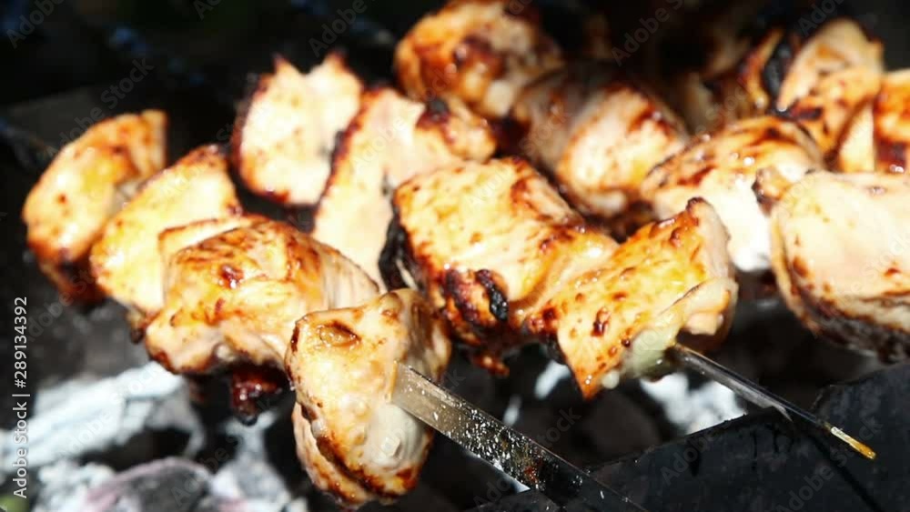 Meat pieces being fried on a charcoal grill. Grilling meat during outdoor recreation. Meat pieces being fried on a charcoal grill. Grilling meat during outdoor recreation.