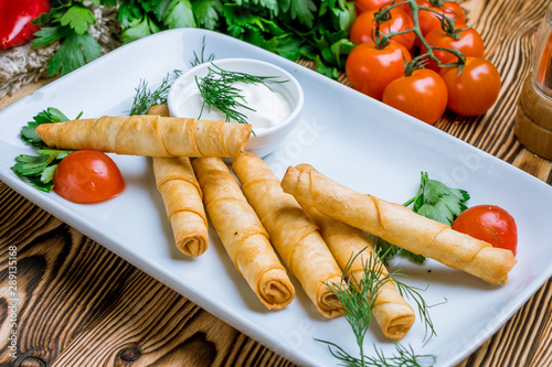 sigara Burek on wooden table Turkish cuisine photo