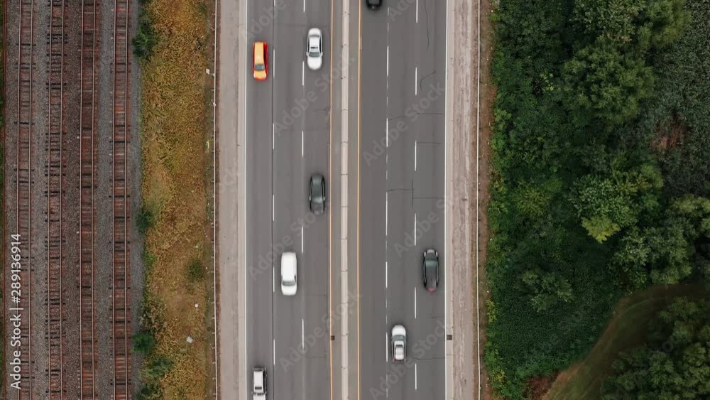 Aerial establishing shot of highway traffic on an overcast day. Cinematic 4K footage. Aerial establishing shot of highway traffic on an overcast day. Cinematic 4K footage.