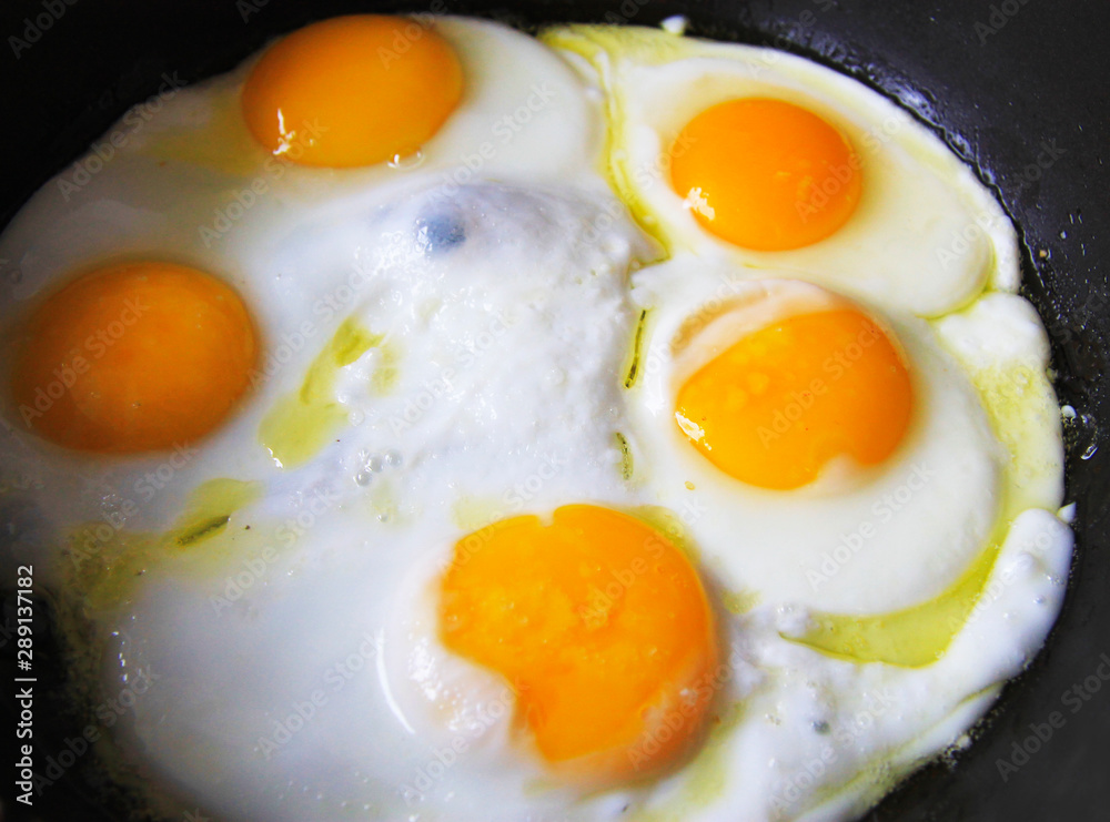 Roasted eggs on the black pan and dill over Roasted eggs on the black pan and dill over