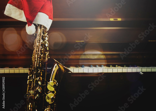 piano keys  and Saxophone with Santa clause hat in the night at home, Christmas music  background with copy space