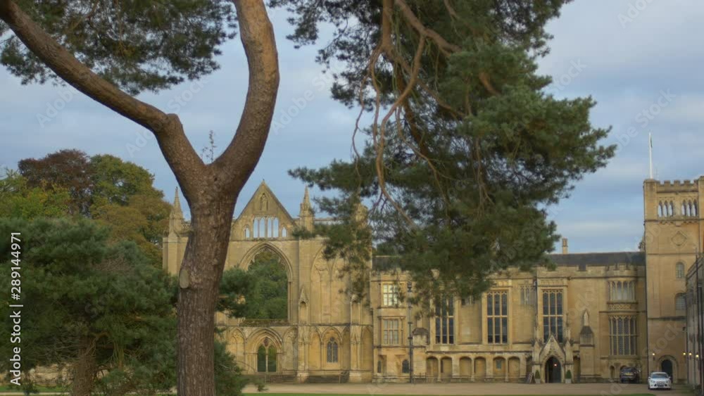 Tilt Up Shot Of Newstead Abbey In Nottingham, England. Tall Tree Sat Infront. Tourist Attraction Tilt Up Shot Of Newstead Abbey In Nottingham, England. Tall Tree Sat Infront. Tourist Attraction