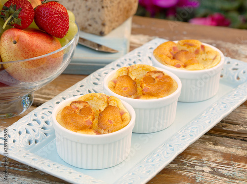 Miniture Ham Souffles in ramakin bowls in outdoor garden setting.