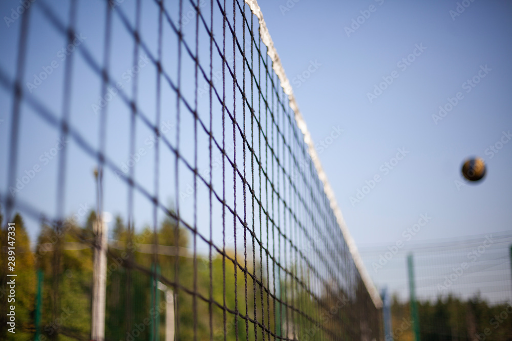 Volleyball net stretched above the ground. Sports equipment for playing ball. Sports game volleyball. Volleyball net stretched above the ground. Sports equipment for playing ball. Sports game volleyball.