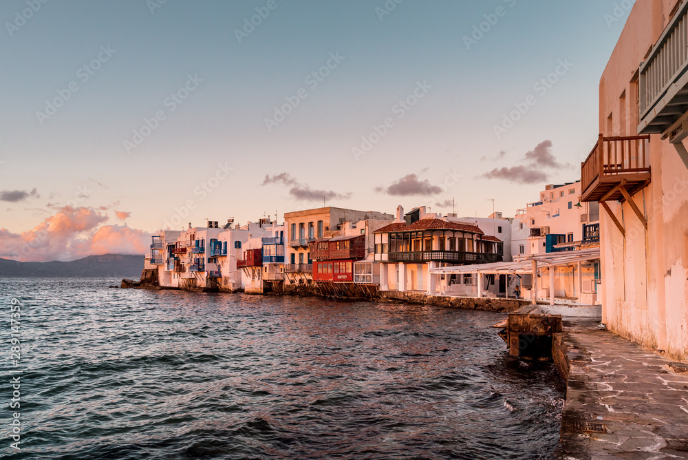 Waterfront of Little Venice Mykonos at sunset, white houses and colorful wooden balconies in the evening light, typical Cycladic architecture, Cyclades, Greece