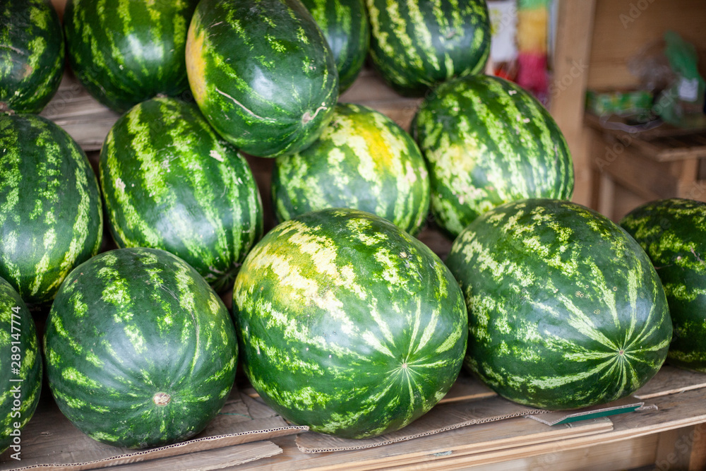 Watermelons in the market. Big berry. Juicy watermelon lies on the counter. Southern fruit. Watermelons in the market. Big berry. Juicy watermelon lies on the counter. Southern fruit.