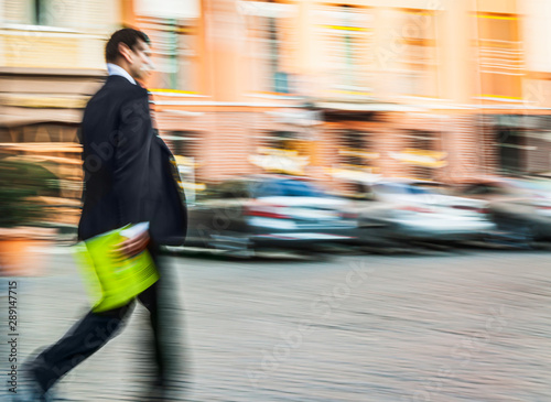Businessman in a suit walks down the street