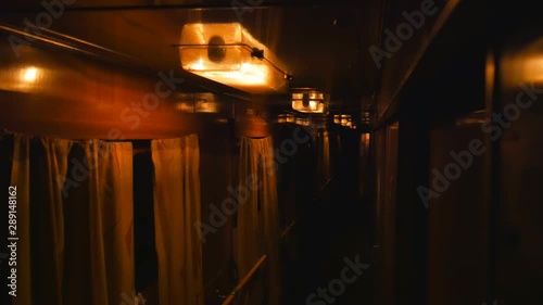 Very dark in a train car. Interior inside lifestyle train, view corridor in the compartment car from night moving train railway Ukrain.