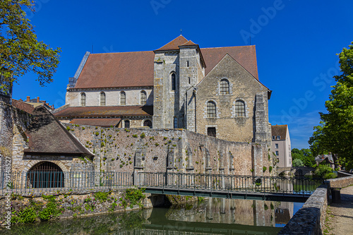 View of Chartres Church of Saint Andrew (La Collegiale Saint-Andre, XII century) - old collegiate church, reflected in the river Eure. Chartres (80 km southwest of Paris), Eure-et-Loir, France.