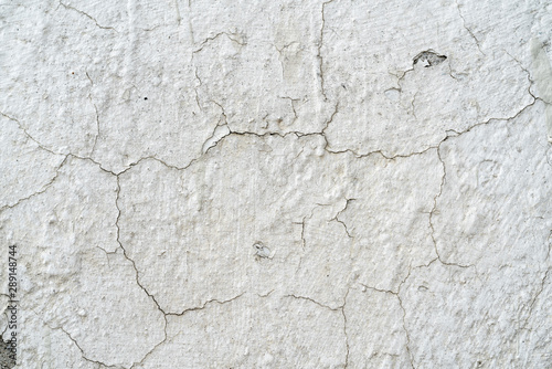 White and beige paint on the wall of a house. Construction and repair.