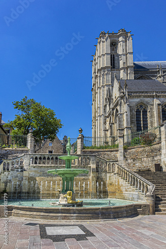 Limestone staircase and fountain date to 1853 near Le Mans Roman Catholic cathedral of Saint Julien (Cathedrale St-Julien du Mans, VI - XIV century). Le Mans, Pays de la Loire region in France.
