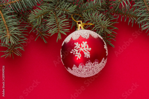 Christmas and New Year background. Christmas tree toy on a red background. Place for text.