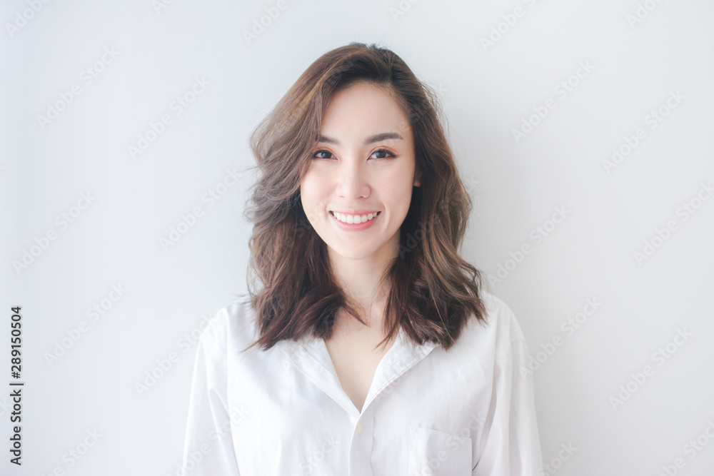 Indoor portrait of beautiful brunette young woman with smiling cheerfully, showing her white teeth to camera Indoor portrait of beautiful brunette young woman with smiling cheerfully, showing her white teeth to camera