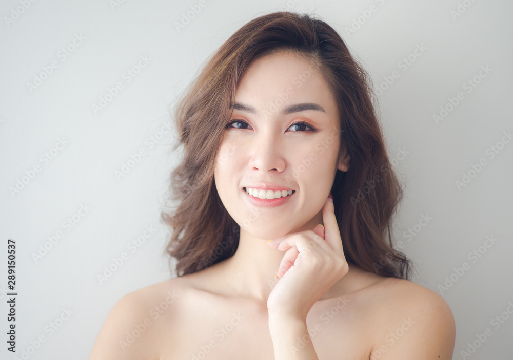 Beauty Asian Woman face Portrait. Beautiful Spa model Girl with Perfect Fresh Clean Skin. Blonde female looking at camera and smiling. Youth and Skin Care Concept Beauty Asian Woman face Portrait. Beautiful Spa model Girl with Perfect Fresh Clean Skin. Blonde female looking at camera and smiling. Youth and Skin Care Concept