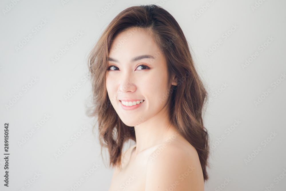 Beauty Asian Woman face Portrait. Beautiful Spa model Girl with Perfect Fresh Clean Skin. Blonde female looking at camera and smiling. Youth and Skin Care Concept Beauty Asian Woman face Portrait. Beautiful Spa model Girl with Perfect Fresh Clean Skin. Blonde female looking at camera and smiling. Youth and Skin Care Concept