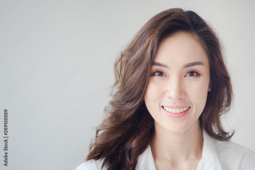 Indoor portrait of beautiful brunette young woman with smiling cheerfully, showing her white teeth to camera with copy space Indoor portrait of beautiful brunette young woman with smiling cheerfully, showing her white teeth to camera with copy space