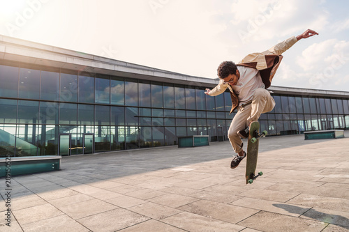 Afro skateboarder jumped in air with skateboard