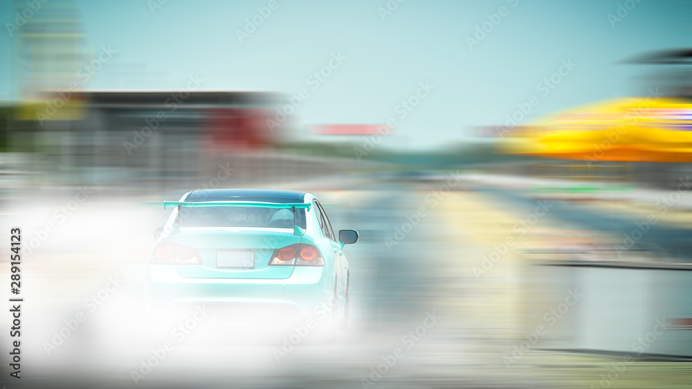 Car drifting with a lot of smoke on a blurred background.