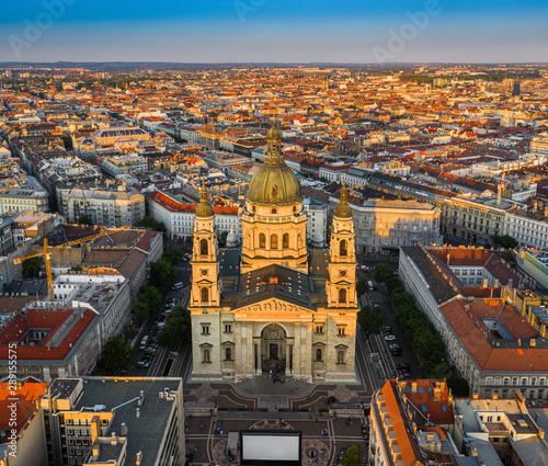 Budapest, Hungary - Aerial drone view of the beautiful St. Stephen's Basilica from high above at sunset with warm summer afternoon lights and clear blue sky