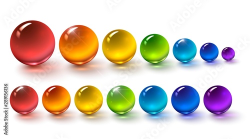 Set of multi-colored glass balls on a white background, round drops of rainbow colors