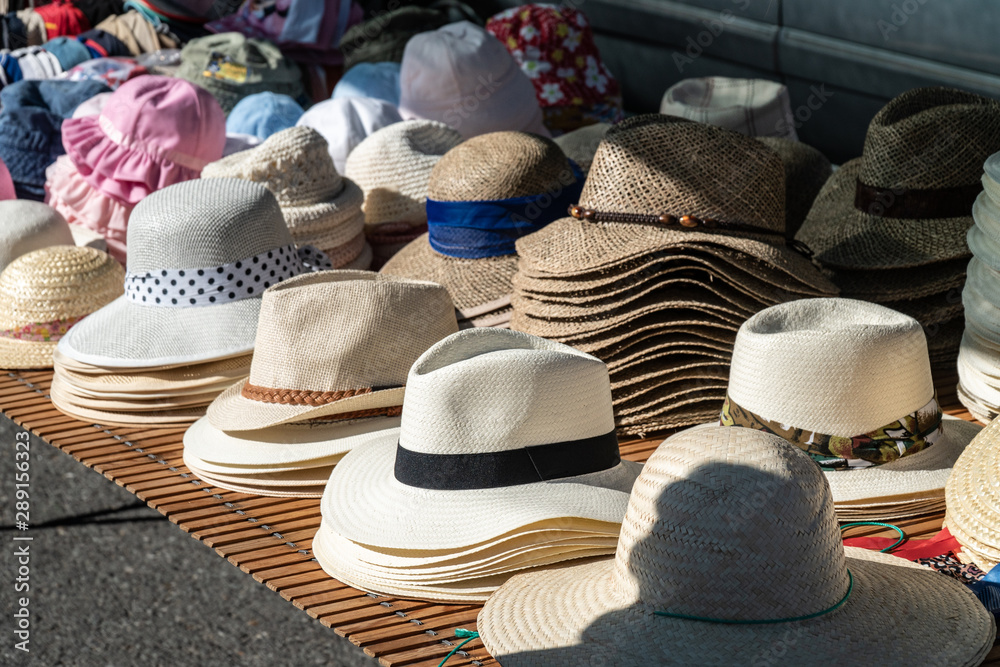 Group of hats for sale at outdoor market