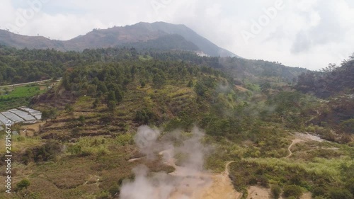 plateau with volcanic activity, mud volcano Kawah Sikidang, geothermal activity and geysers. aerial view volcanic landscape Dieng Plateau, Indonesia. Famous tourist destination of Sikidang Crater it photo