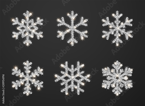Shining silver snowflakes on black background. Christmas and New Year background. Vector illustration