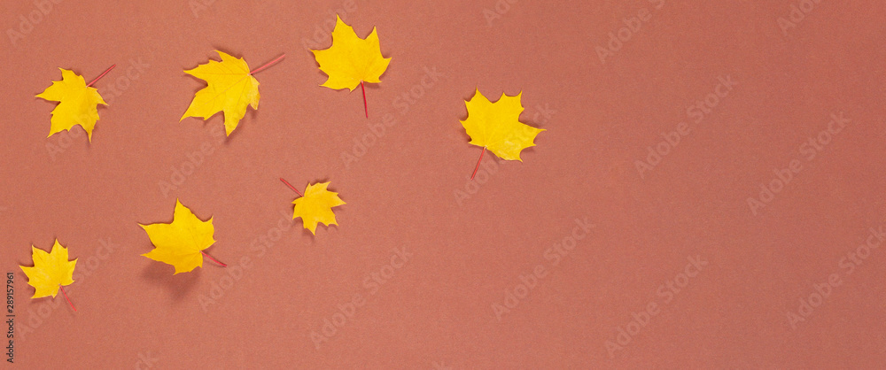 Autumn composition. Frame made of autumn maple leaves on brown background Autumn composition. Frame made of autumn maple leaves on brown background