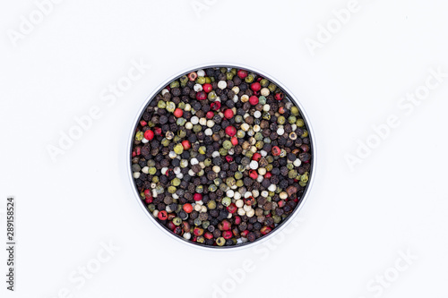 Top view dry pepper mix. Black, white, green and red pepper.