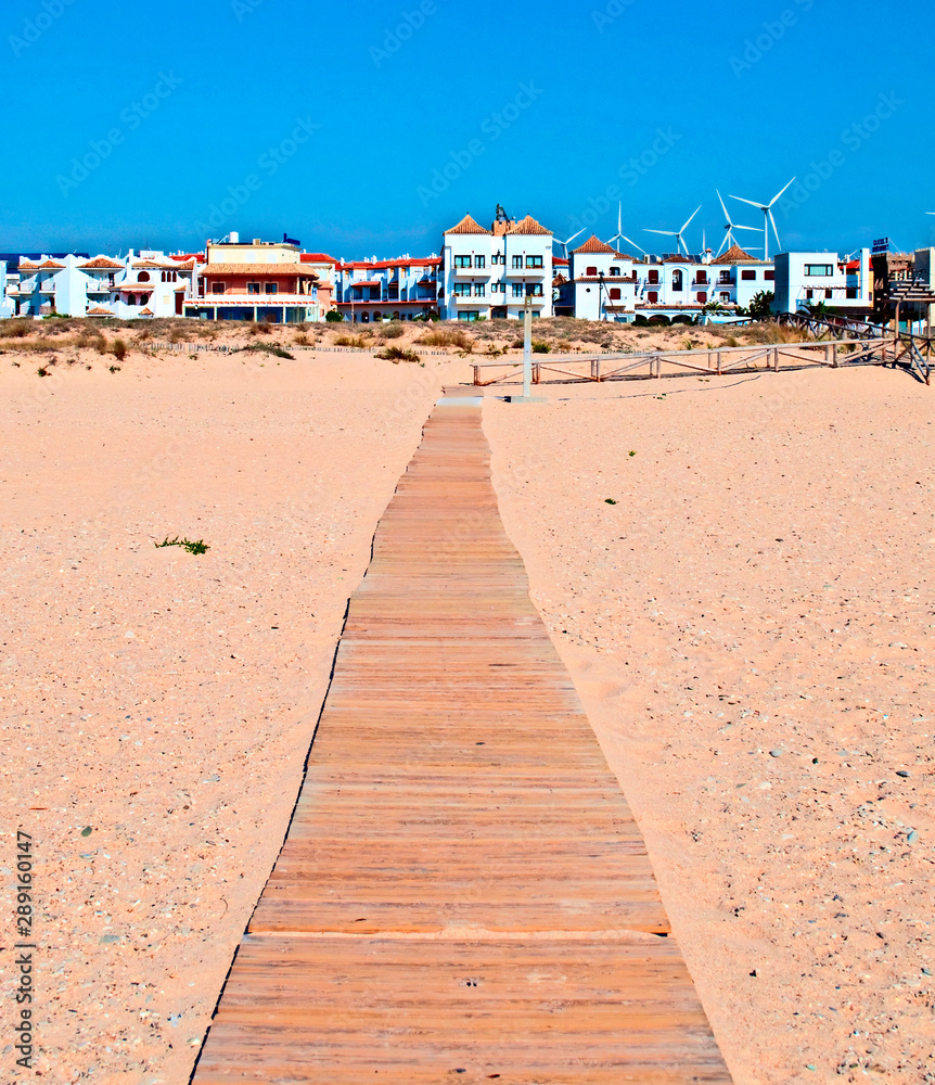 Path of wooden planks next to the sand beach located in the Spanish town of Zahara Path of wooden planks next to the sand beach located in the Spanish town of Zahara