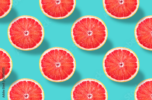 Vivid fruit pattern of fresh grapefruit on colourful background photo