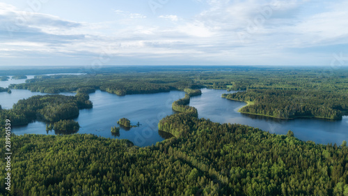 Beautiful lakes and green forest at bright sunrise. Morning in countryside concept. Aerial panorama.