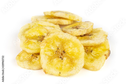 Lot of slices of sweet yellow dry banana isolated on white background